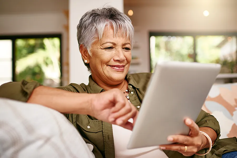 boomer woman on an ipad smiling